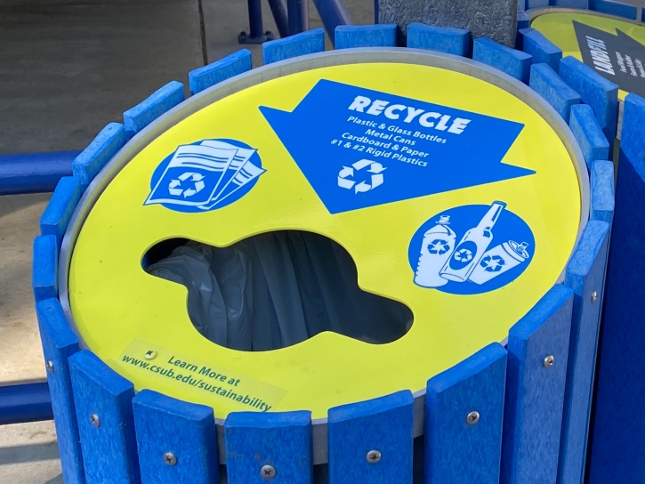 Blue and yellow recycling bin