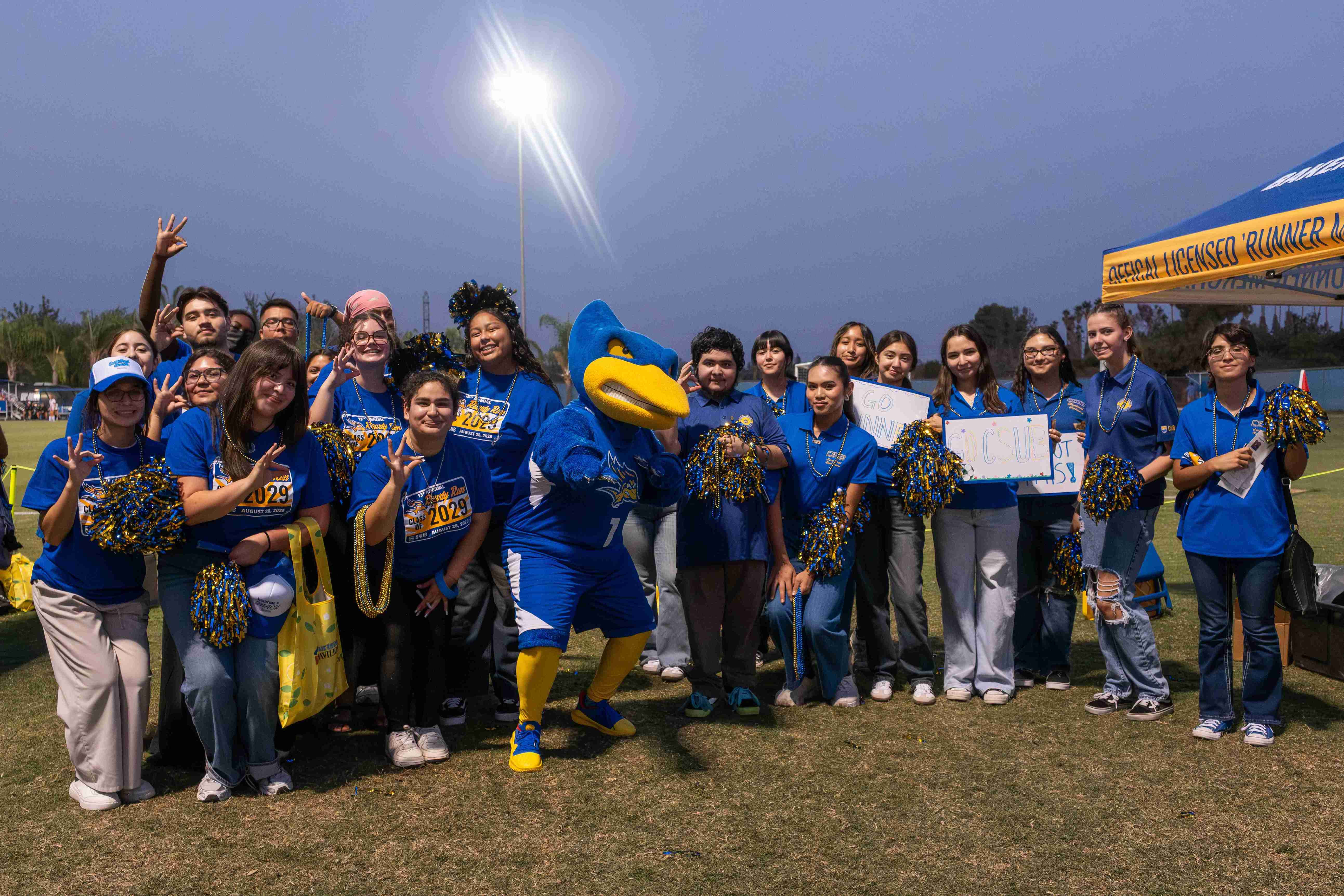 students having run at an athletic event posing for a picture