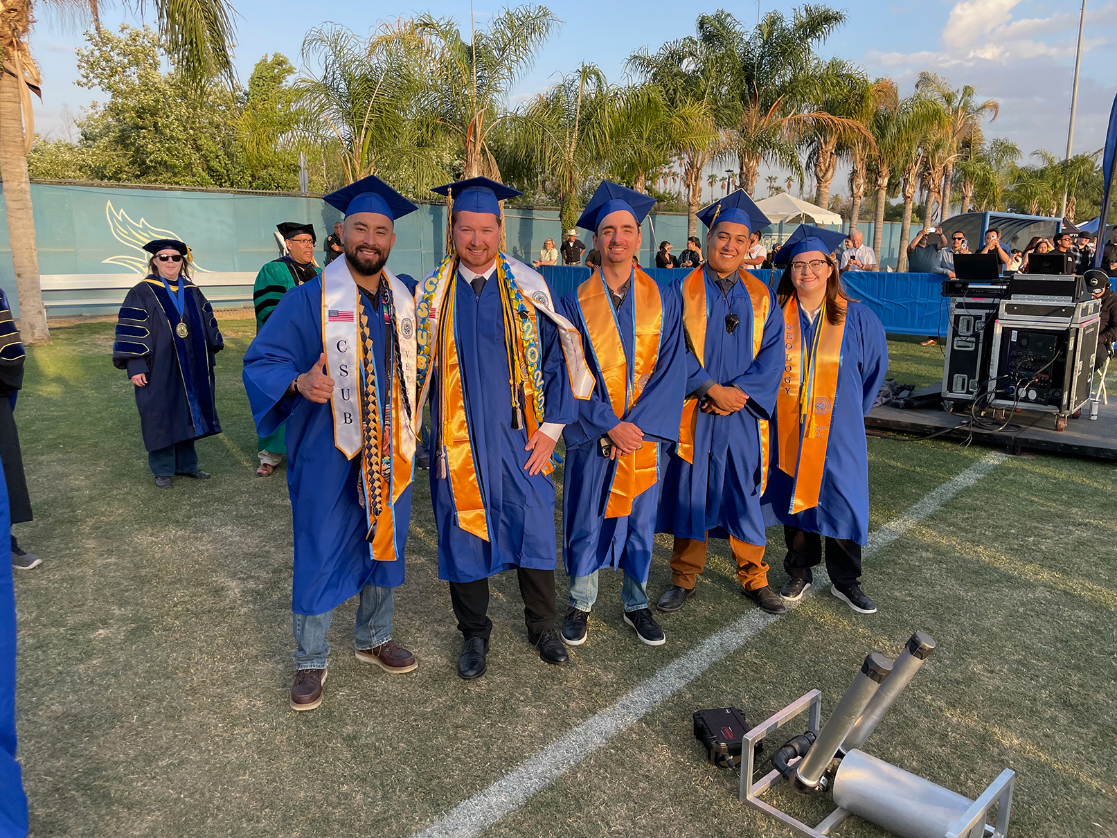 All five smiling graduates: Eder, Braedon, Ryan, Angel, and Madison